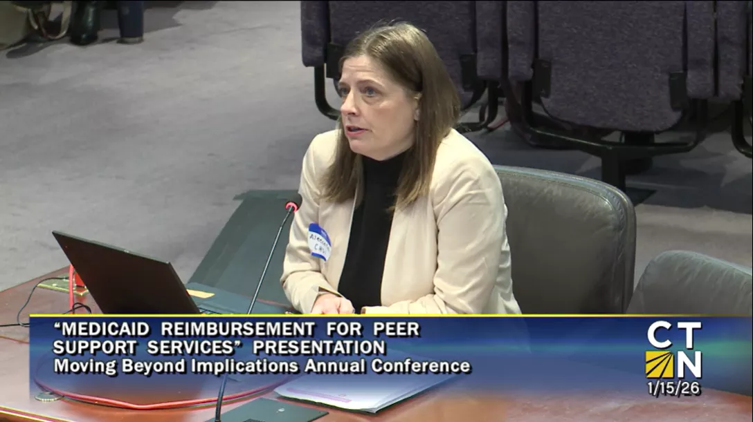 Aleece Kelly presenting at CT legislative office building in screenshot from CT-N