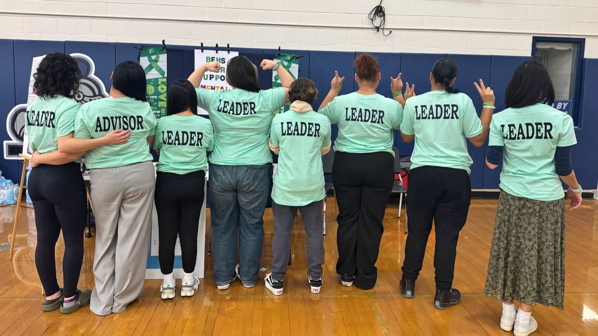 The Bristol Eastern High School peer support team posing with matching T-shirts at a student mental health event.