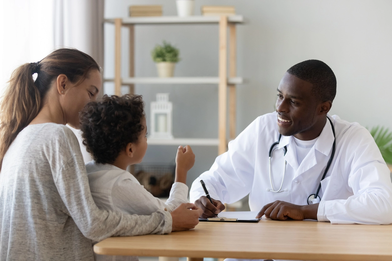 Doctor speaking to a mother with her toddler