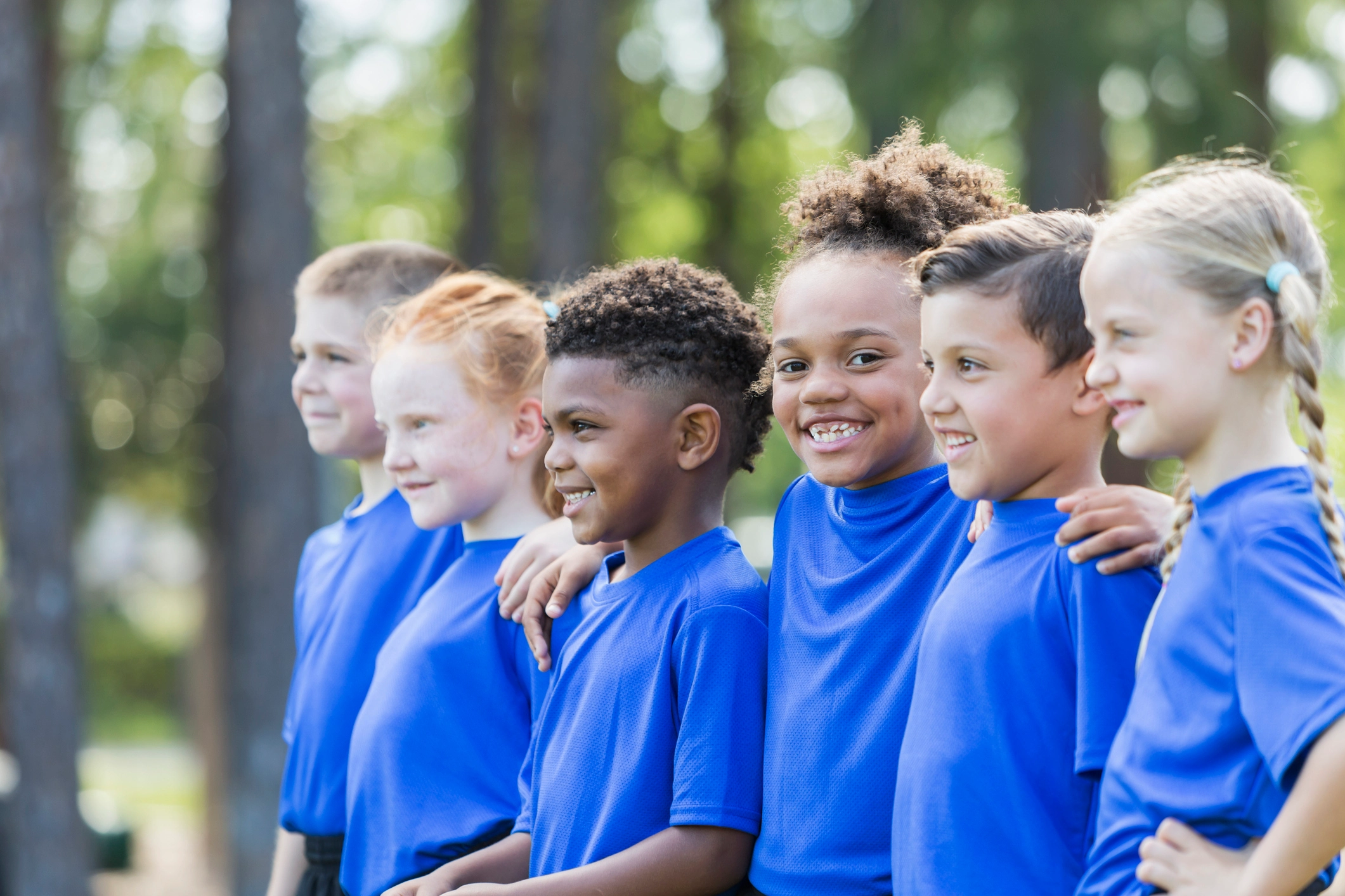 a group of children smiling and laughing