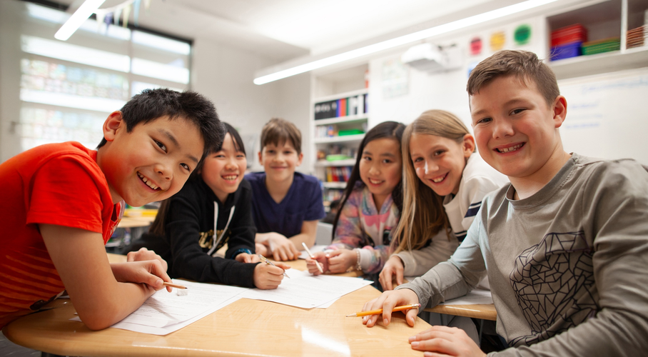 Students at a group table in school.