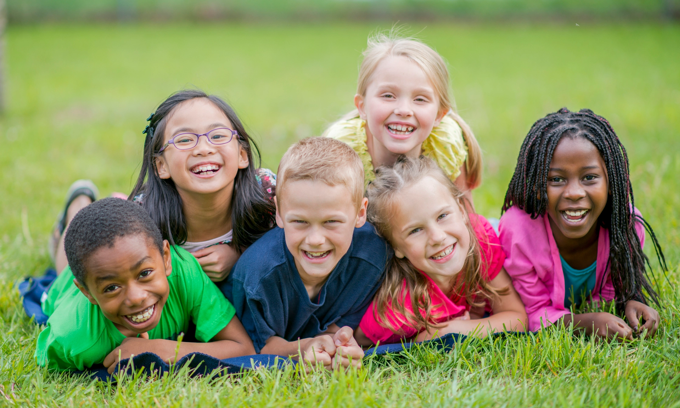 a group of children smiling and laughing
