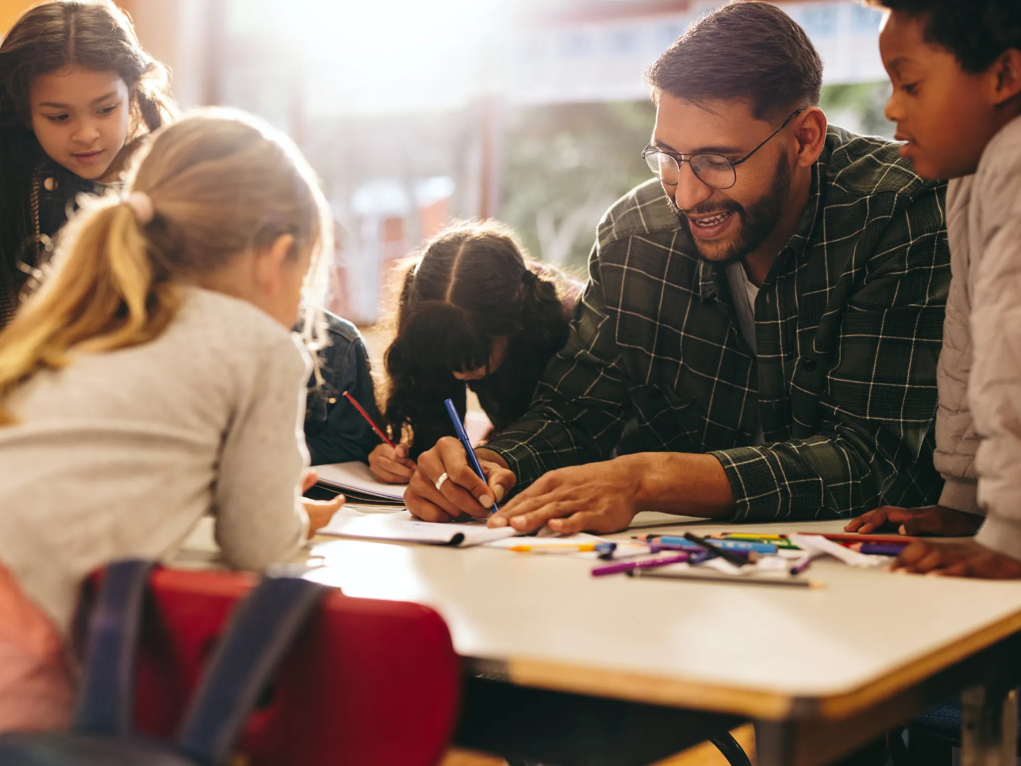 Teacher works with a group of elementary age children