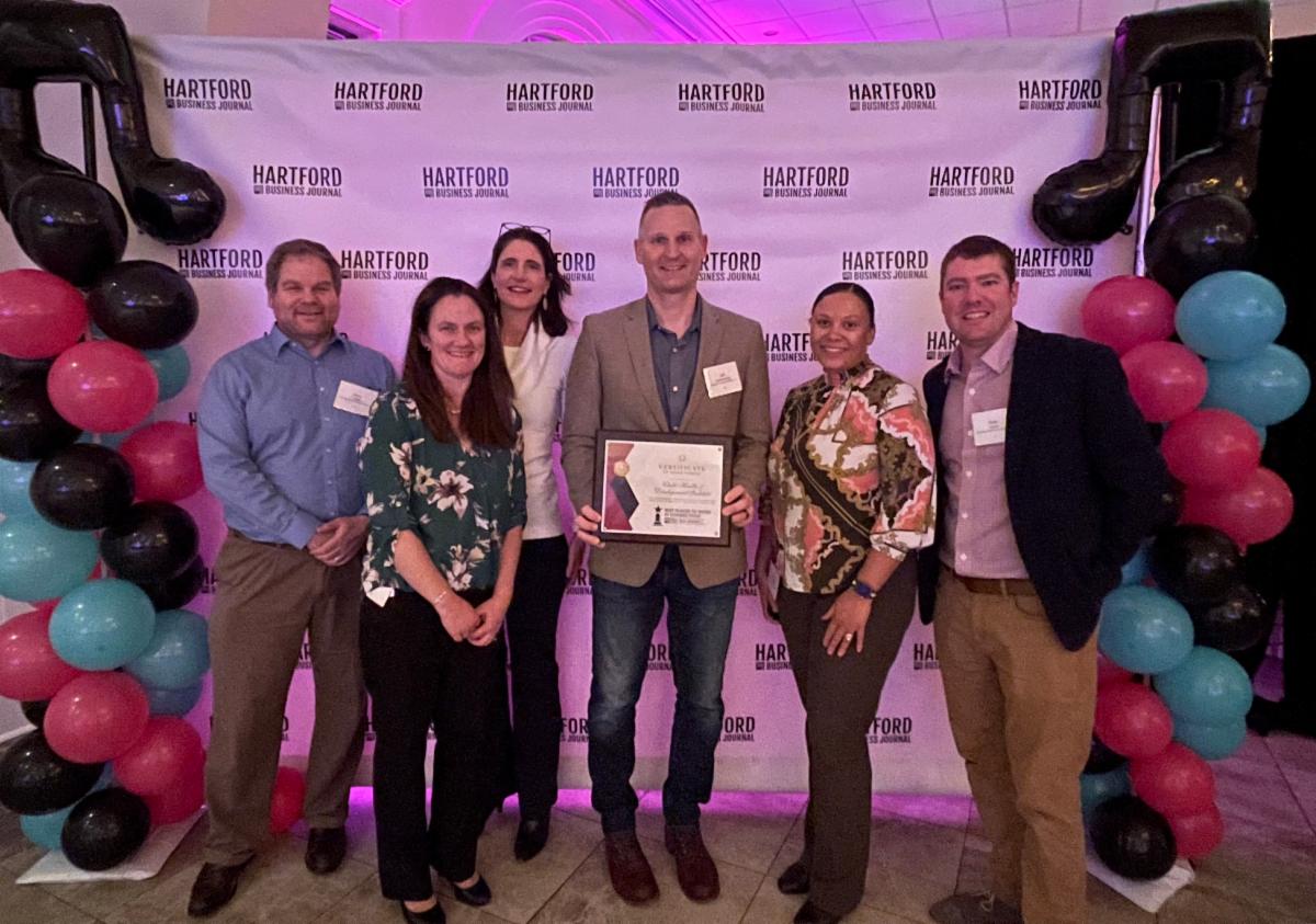 HBJ Best Places to Work Staff 2023 A group of CHDI staff pose with the 2023 HBJ Best Places to Work Award at a ceremony.